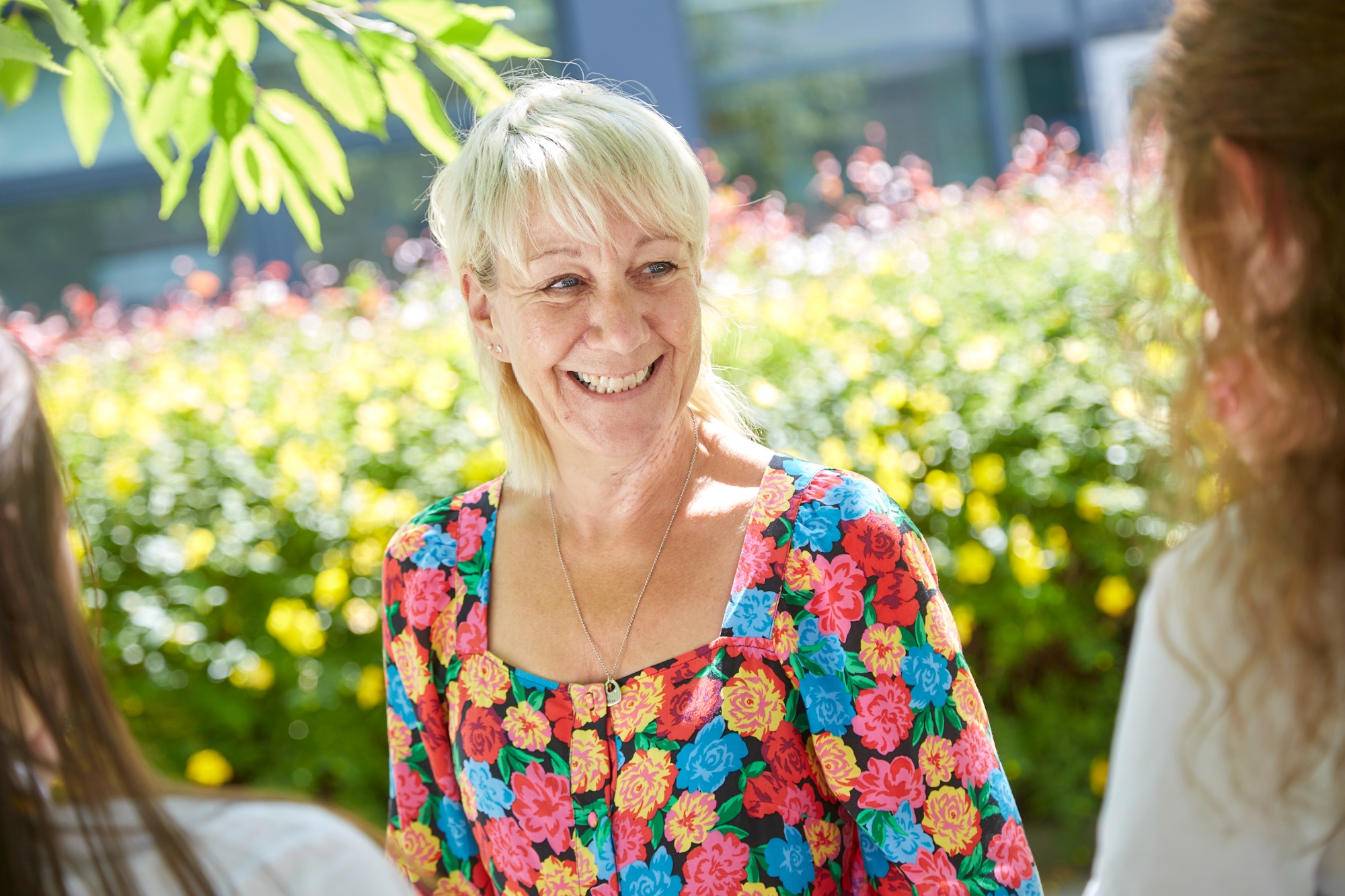 Staff member smiling at students
